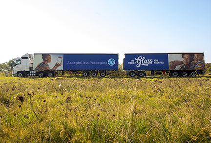 Image of a smart truck with a green field in the foreground